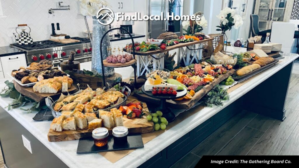 Cozy and inviting scene of The Gathering Board in Holly Springs, GA, showcasing beautifully crafted charcuterie boards with a variety of meats, cheeses, fruits, and nuts in a beautiful modern kitchen.